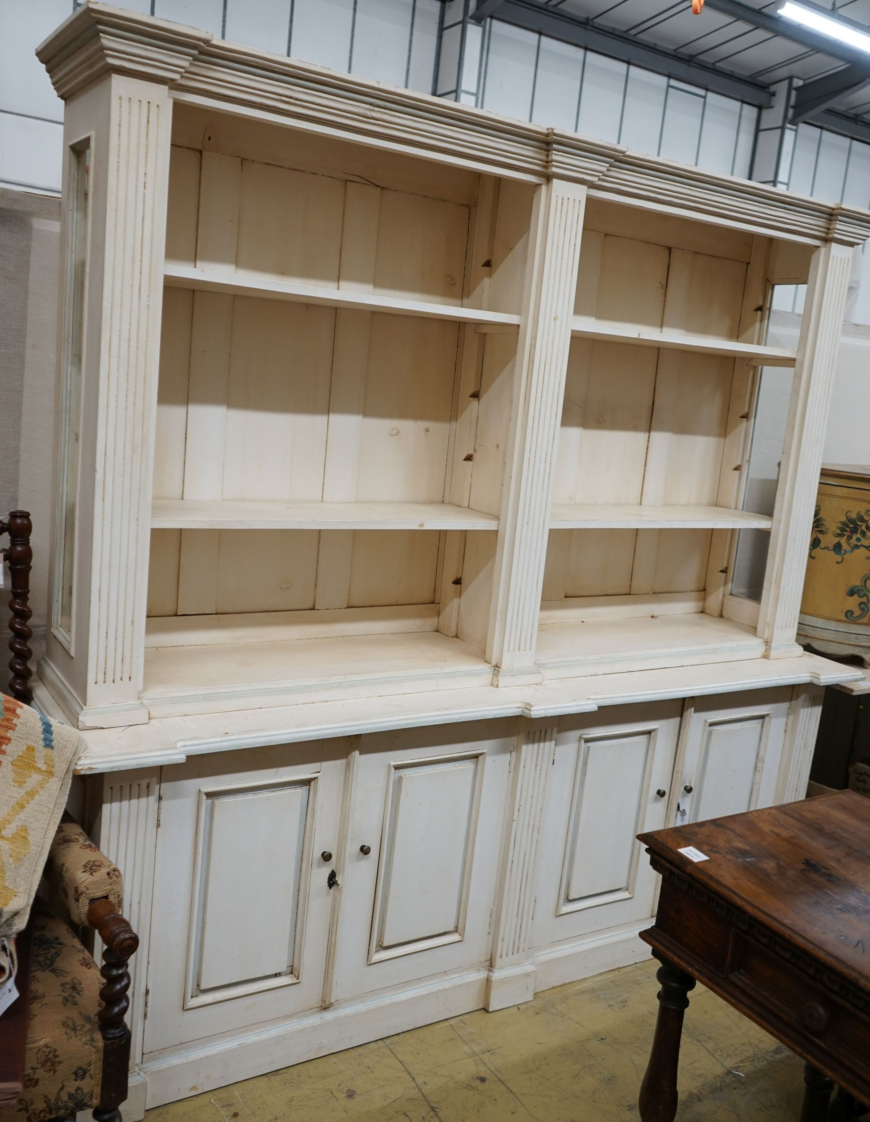 A modern George III style painted library bookcase, width 220cm depth 53cm height 208cm